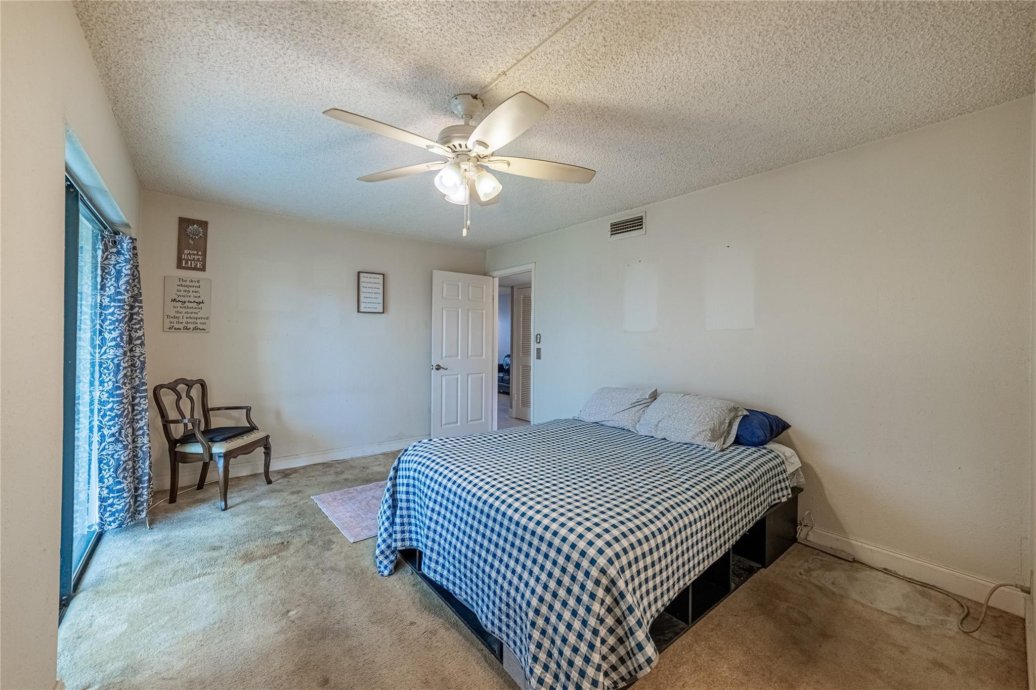 103 Capri B, Unit 103 Delray Beach, FL 33484 - Photo 23 of 24 a bedroom with a bed and a chandelier