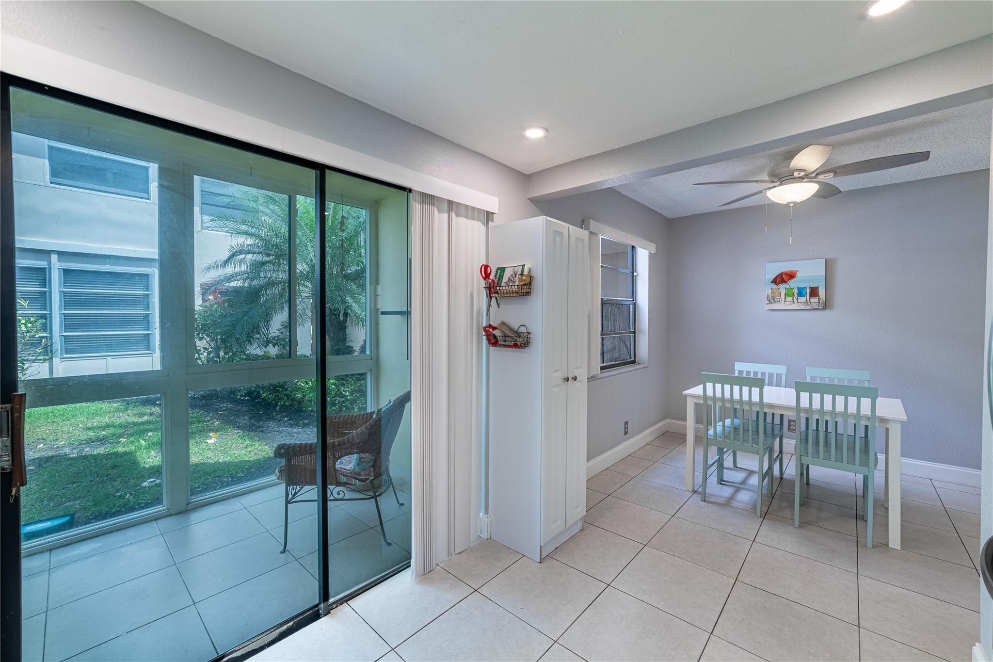 103 Capri B, Unit 103 Delray Beach, FL 33484 - Photo 4 of 24 a bathroom with a glass door shower and a yard