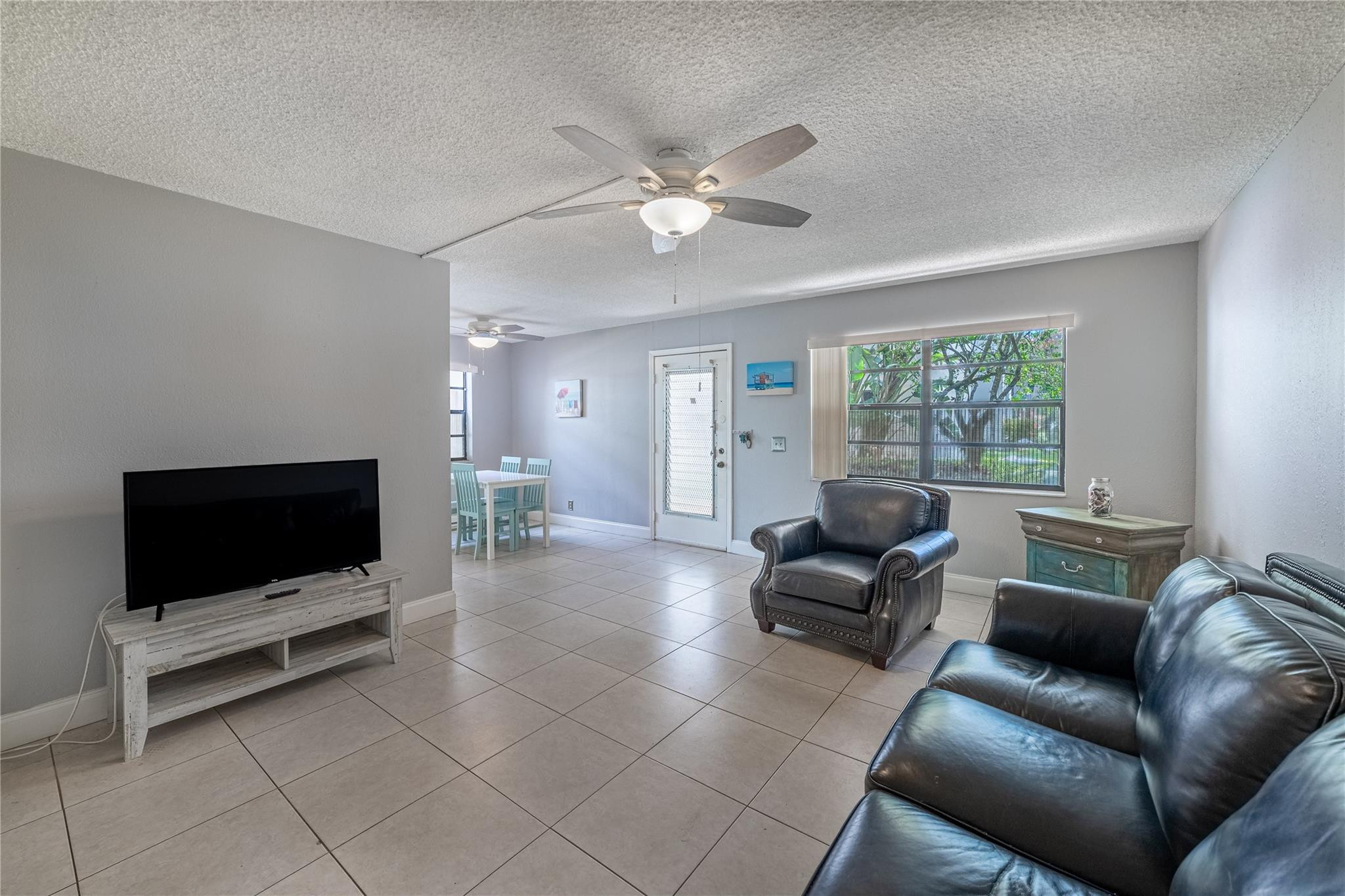 103 Capri B, Unit 103 Delray Beach, FL 33484 - Photo 7 of 24 a living room with furniture and a flat screen tv