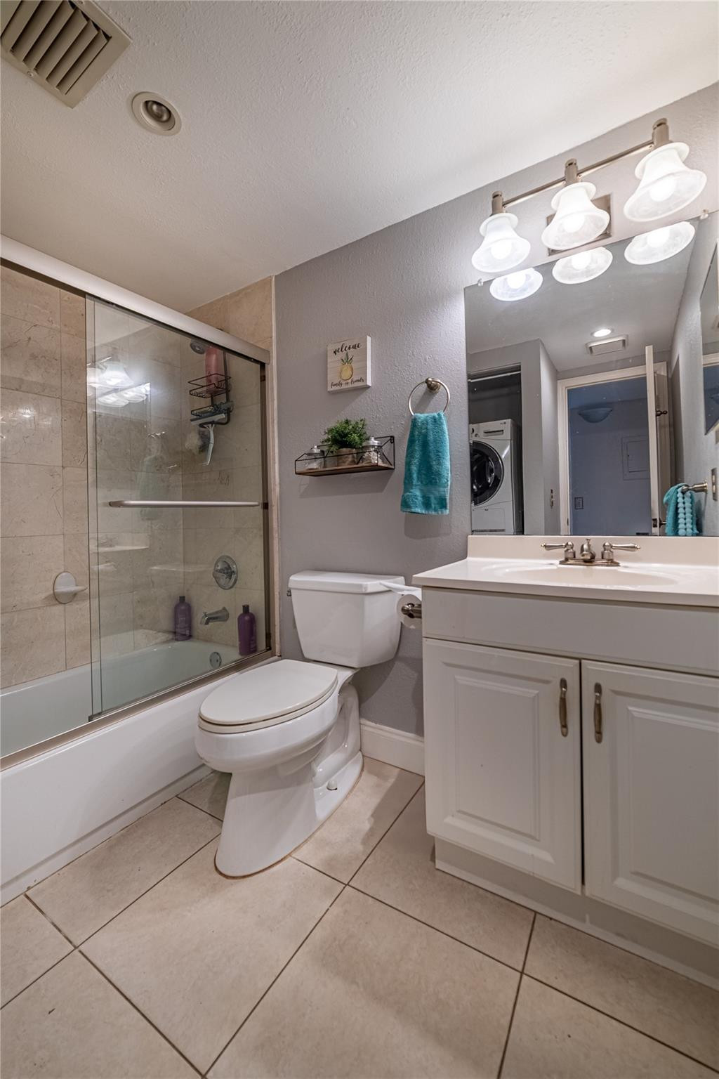 103 Capri B, Unit 103 Delray Beach, FL 33484 - Photo 10 of 24 a bathroom with a toilet sink and mirror