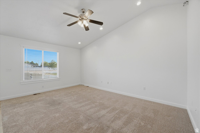 791 East Saddle Road Grantsville, UT 84029 - Photo 15 of 46 Vaulted ceiling room featuring a large window with blinds, a ceiling fan with integrated lighting, recessed lighting, and neutral carpet flooring