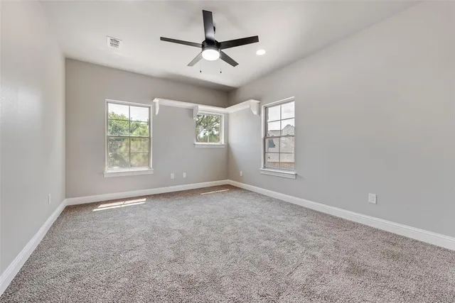 a view of a livingroom with a ceiling fan and window