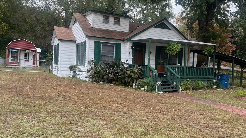 413 Park Avenue Minden, LA 71055 - Photo 1 of 5 a front view of a house with garden