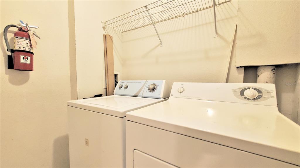 3406 Soho Street, Unit 303 Orlando, FL 32835 - Photo 11 of 19 a utility room with dryer and washer