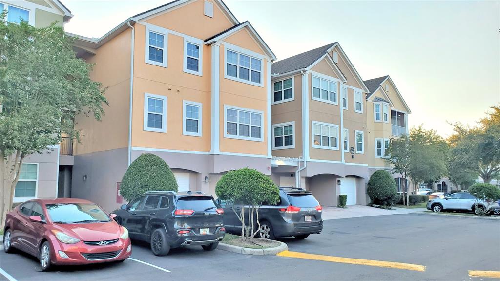 3406 Soho Street, Unit 303 Orlando, FL 32835 - Photo 12 of 19 a car parked in front of a house