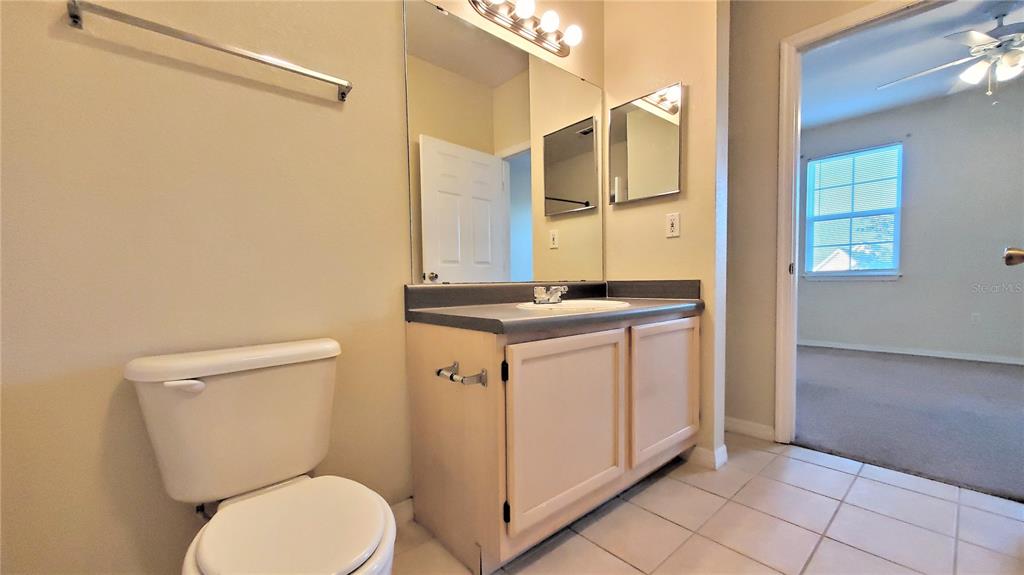 3406 Soho Street, Unit 303 Orlando, FL 32835 - Photo 18 of 19 a bathroom with a sink a toilet and shower