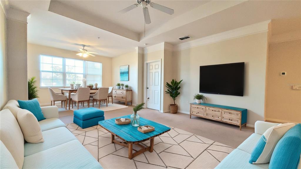 3406 Soho Street, Unit 303 Orlando, FL 32835 - Photo 2 of 19 a living room with furniture and a flat screen tv