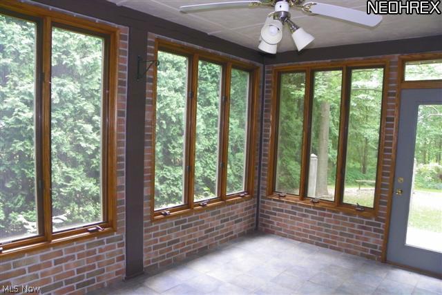 2614 Sweitzer Road Uniontown, OH 44685 - Photo 23 of 25 Heated sunroom off of formal dining w/ fan, ceramic floor & access to deck