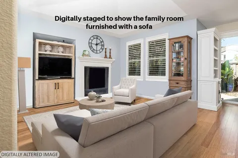 a living room with fireplace furniture and a flat screen tv