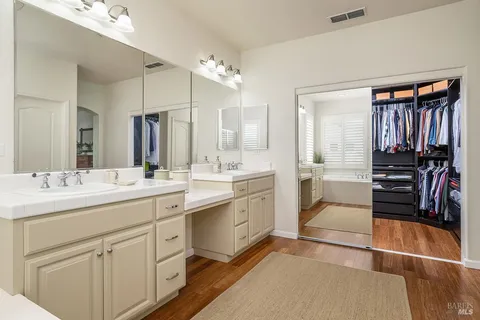 a bathroom with a sink double vanity and a mirror