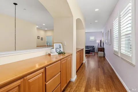a room with counter top space a sink wooden floor and windows