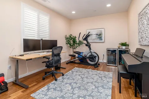 a view of a workspace with furniture and a window