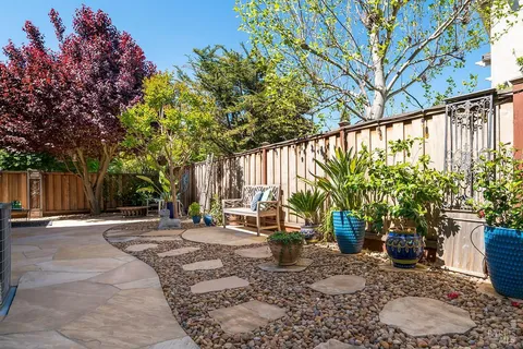 a view of a backyard with sitting area