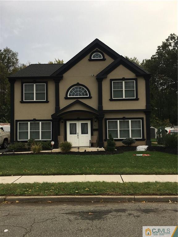 67 Ashley Road Edison, NJ 08817 - Photo 1 of 17 a front view of a house with a yard