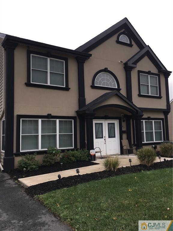 67 Ashley Road Edison, NJ 08817 - Photo 2 of 17 a front view of a house with a yard