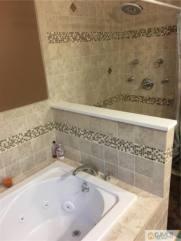 67 Ashley Road Edison, NJ 08817 - Photo 11 of 17 a bathroom with a bathtub and shower