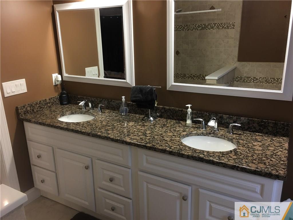67 Ashley Road Edison, NJ 08817 - Photo 12 of 17 a bathroom with a granite countertop double vanity sink and mirror