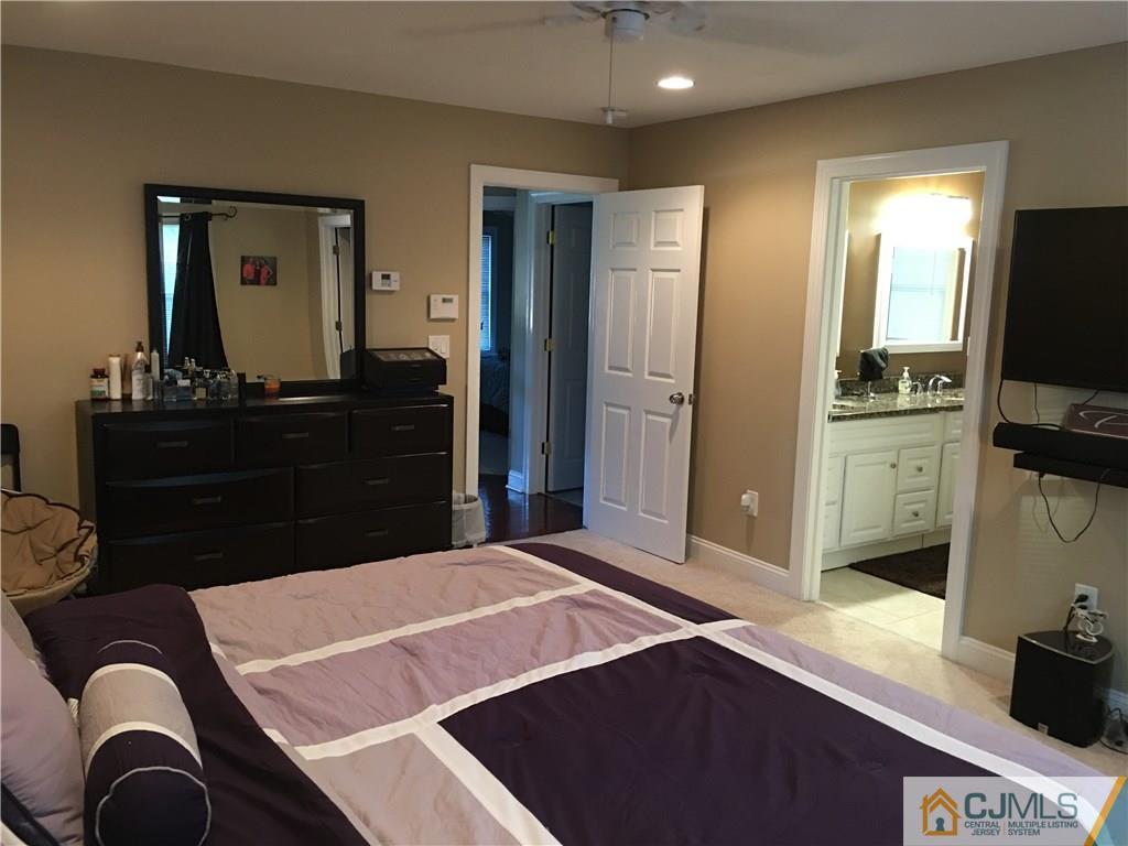 67 Ashley Road Edison, NJ 08817 - Photo 14 of 17 a bedroom with a bed and a flat screen tv