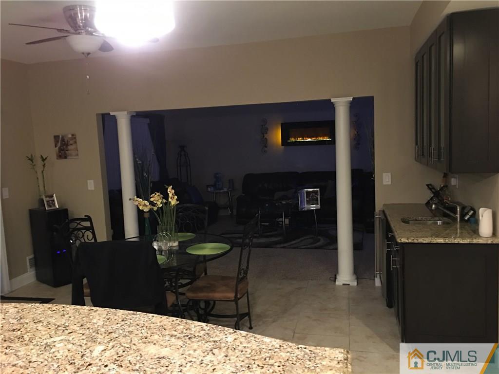 67 Ashley Road Edison, NJ 08817 - Photo 17 of 17 a living room with furniture a flat screen tv and a fireplace