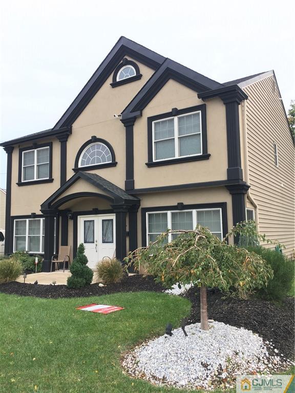 67 Ashley Road Edison, NJ 08817 - Photo 3 of 17 a front view of a house with a yard