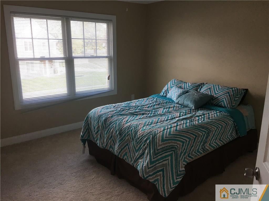 67 Ashley Road Edison, NJ 08817 - Photo 9 of 17 a bed sitting in a bedroom next to a window