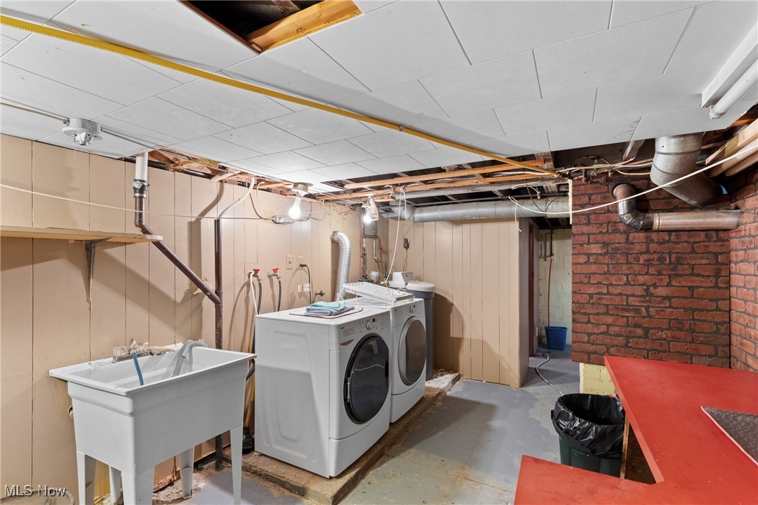 8 Spring Street Bridgeport, OH 43912 - Photo 20 of 34 Laundry area featuring washing machine and dryer and wood walls