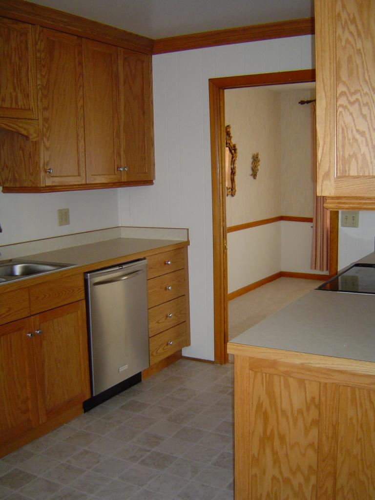 4649 Rosecrest Road Roanoke, VA 24018 - Photo 16 of 24 a kitchen with cabinets and a refrigerator