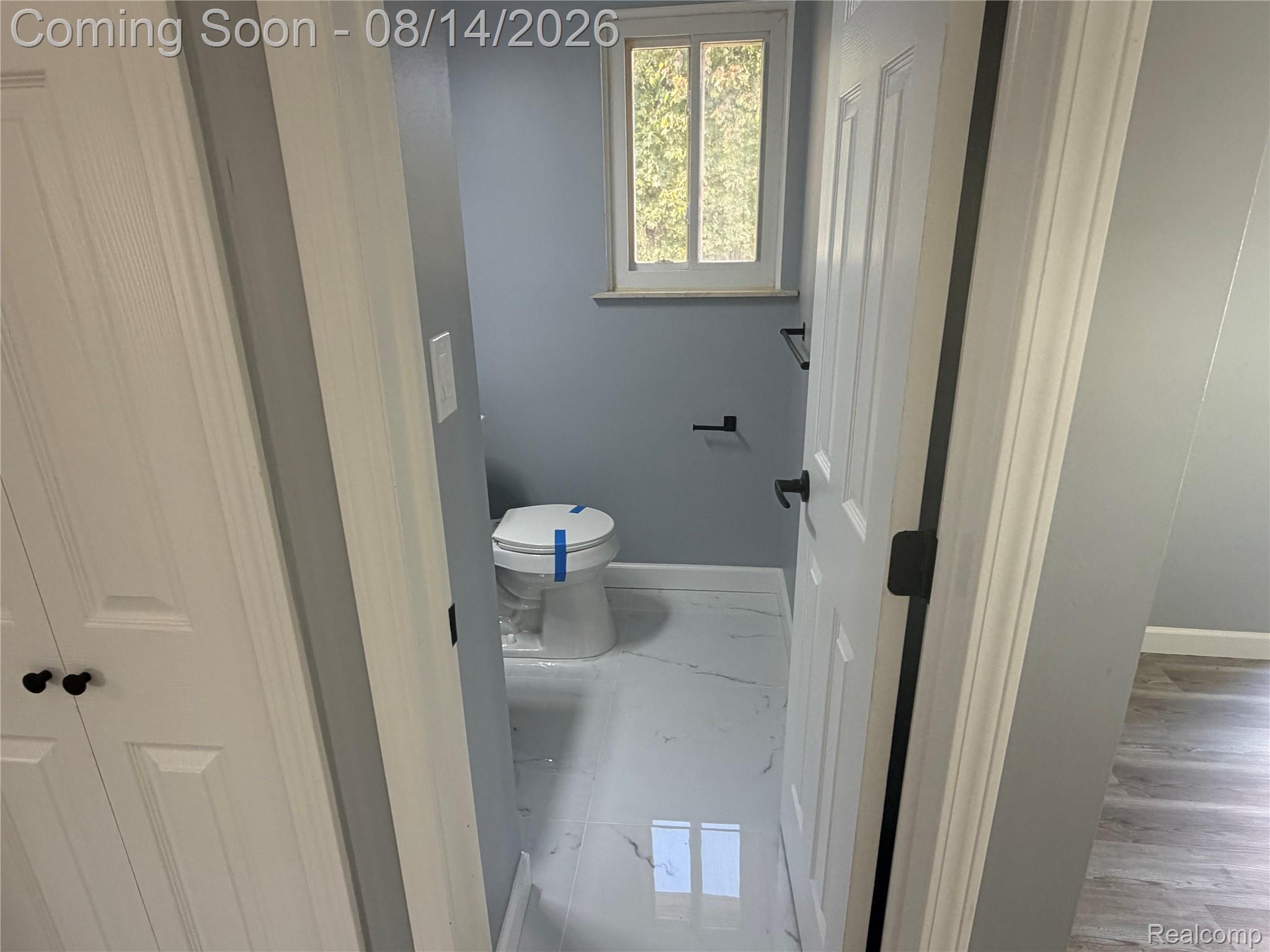 20698 Coachwood Road Riverview, MI 48193 - Photo 12 of 37 Bathroom with white paneled door, black hardware, and light blue walls