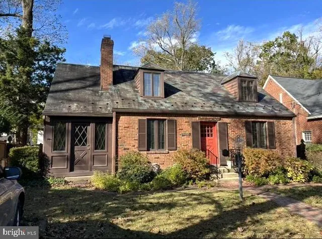 a front view of house with yard and trees around