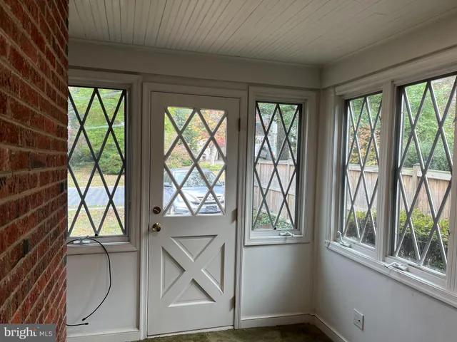 an empty room with wooden floor and cabinet