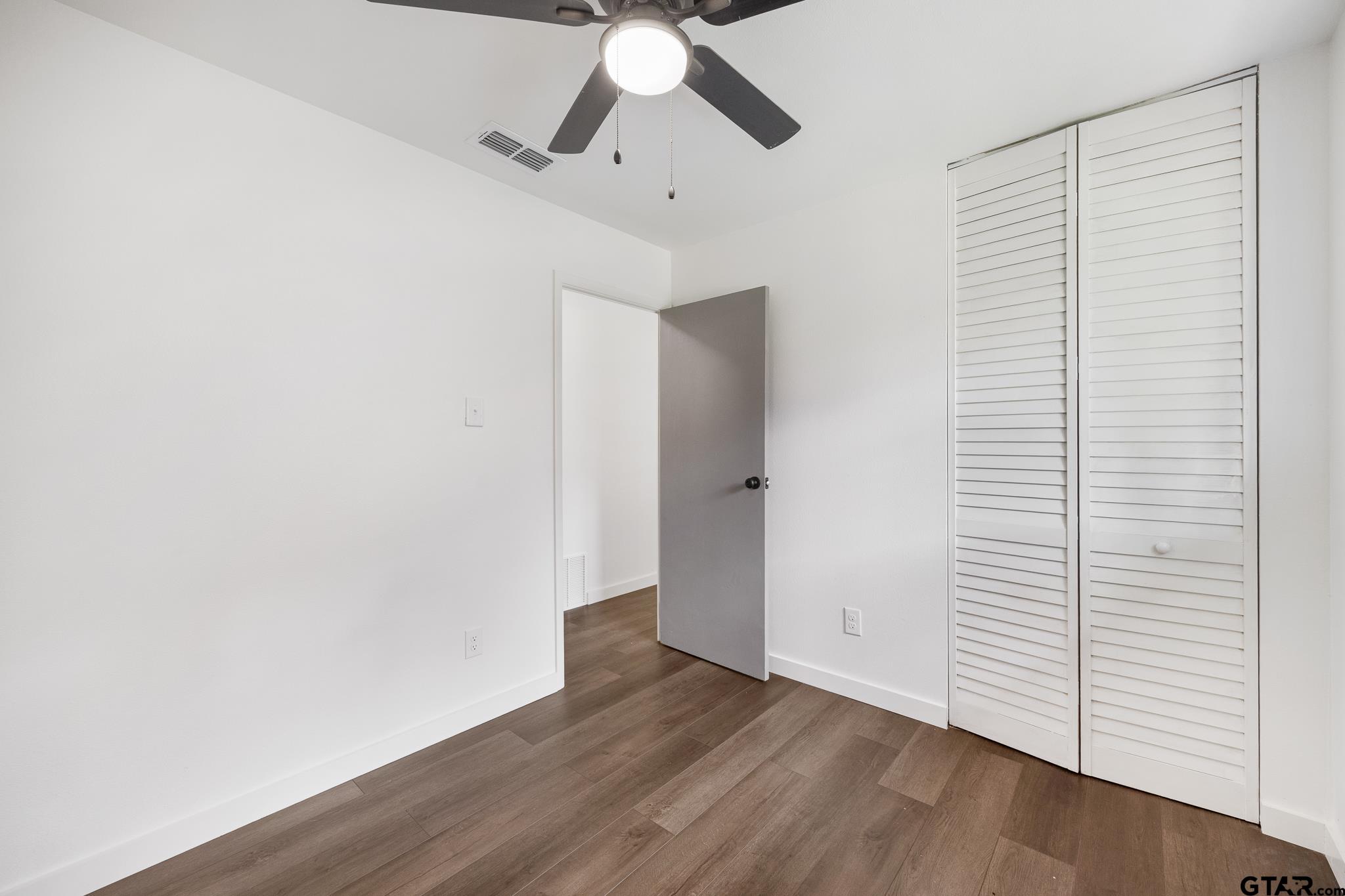 1538 North Hill Road Tyler, TX 75702 - Photo 19 of 29 a view of empty room with wooden floor and ceiling fan