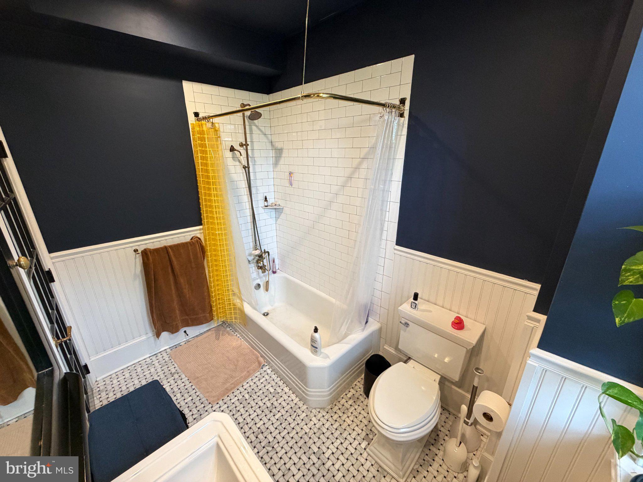 815 South 49th Street Philadelphia, PA 19143 - Photo 31 of 72 a white toilet sitting next to a bathroom sink and a tub