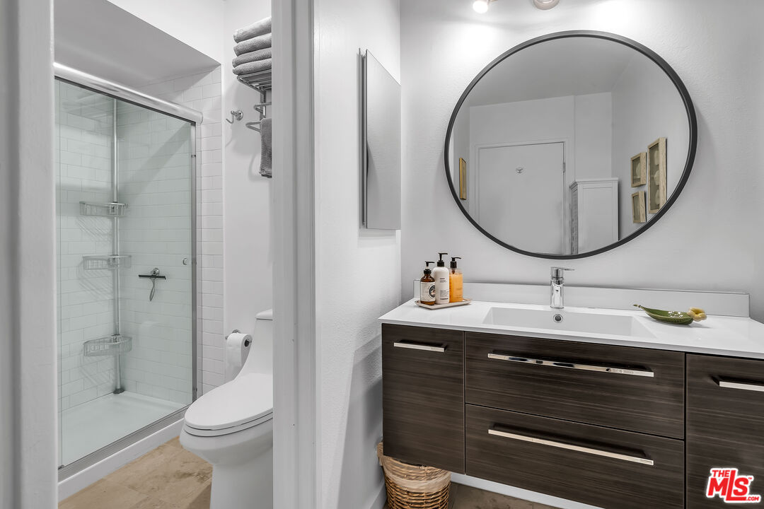 7300 Franklin Avenue, Unit 548 Los Angeles, CA 90046 - Photo 12 of 15 a bathroom with a sink a toilet and a mirror