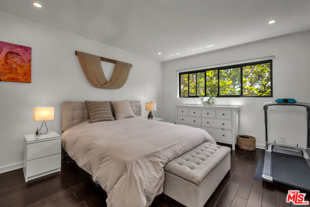 7300 Franklin Avenue, Unit 548 Los Angeles, CA 90046 - Photo 8 of 15 a bedroom with a bed a table and chair