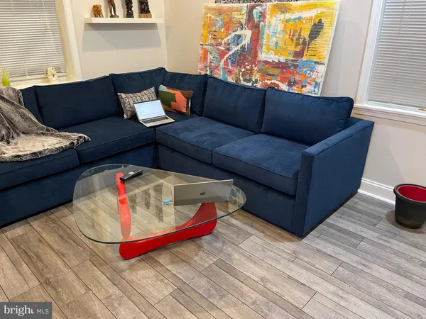 a living room with furniture and wooden floor