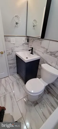 a bathroom with a sink toilet and mirror
