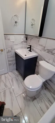 a bathroom with a sink toilet and mirror