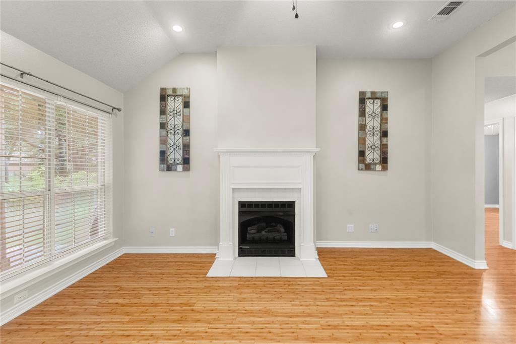 2917 Harlow Road Commerce, TX 75428 - Photo 6 of 40 a view of a livingroom with a fireplace window and wooden floor