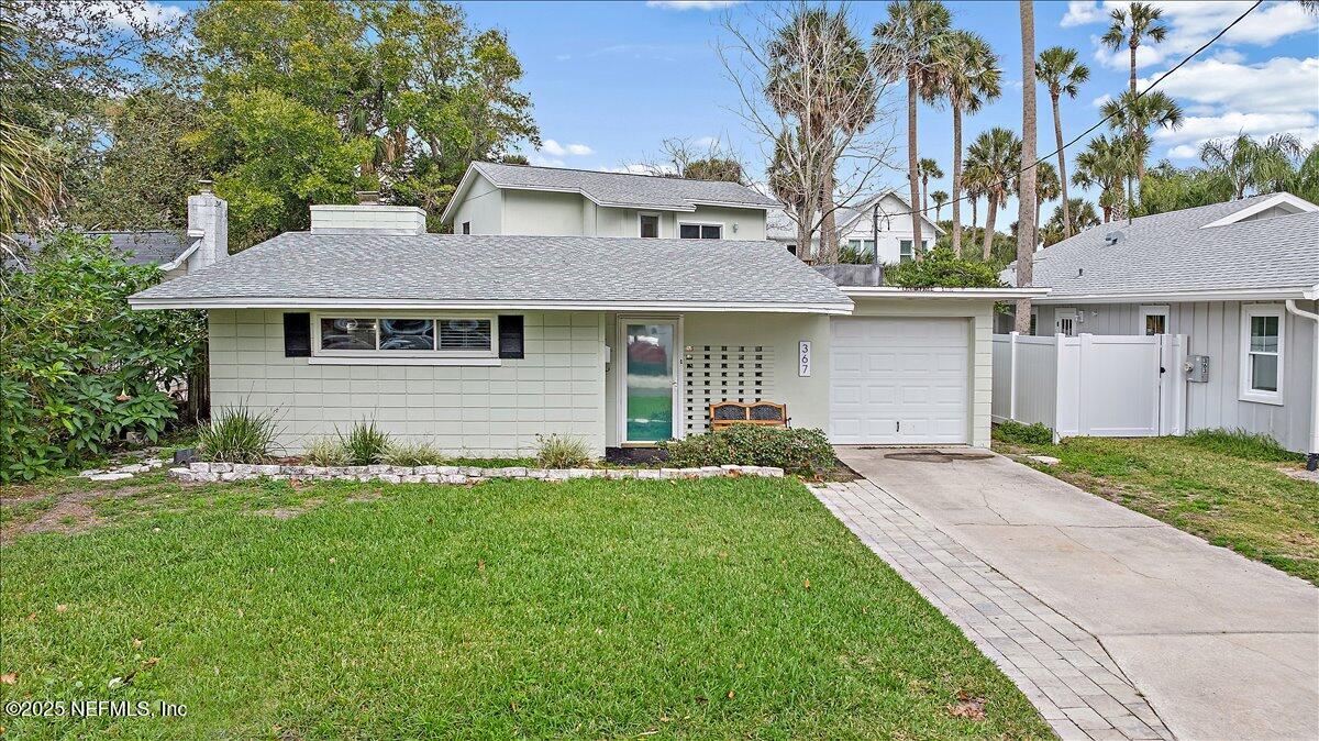 367 7th Street Atlantic Beach, FL 32233 - Photo 1 of 25 a front view of a house with a garden