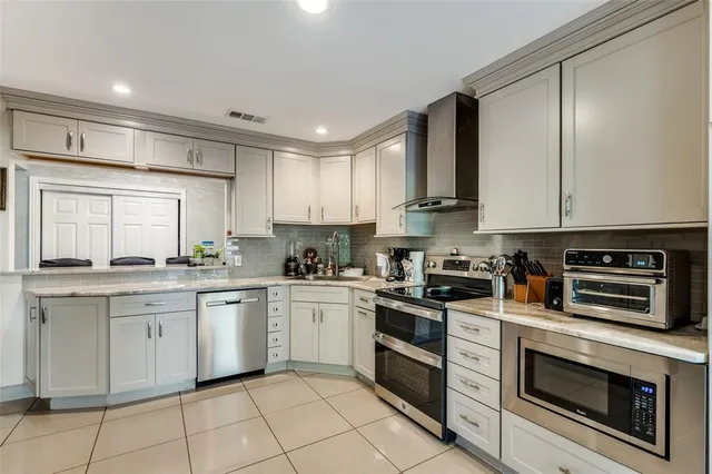a kitchen with a stove top oven sink and cabinets