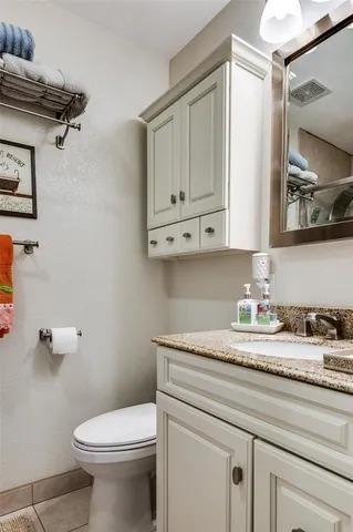 a bathroom with a sink a toilet and mirror