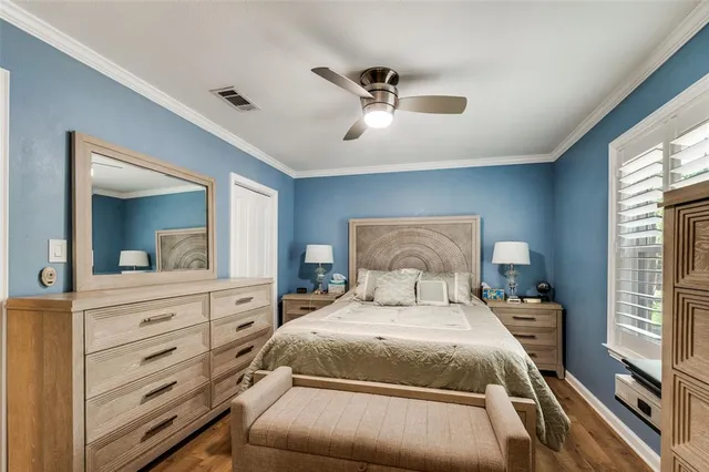 a bedroom with a large bed and a large mirror