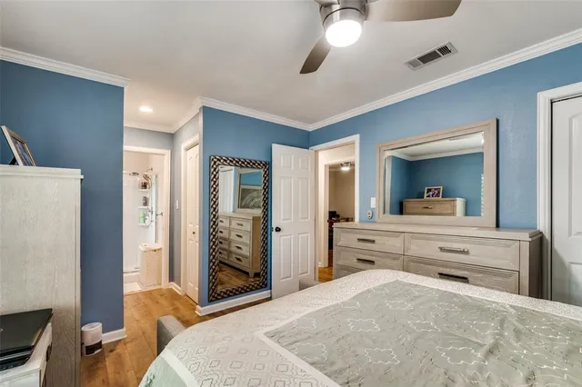 a bedroom with a bed and a large mirror