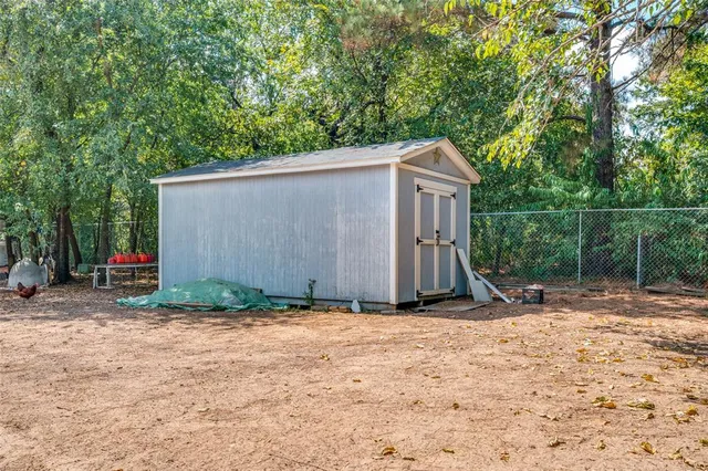 a backyard of a house with lots of plants and entertaining space