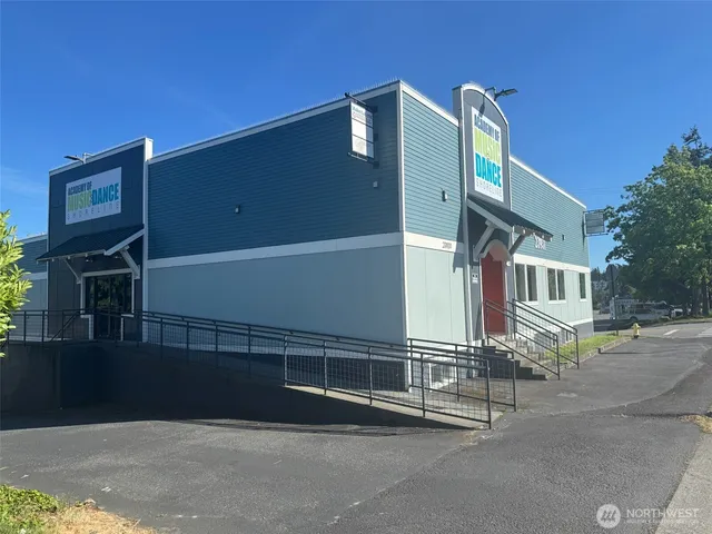 a front view of a house with a road