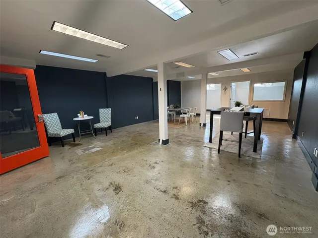 a dining room with furniture a rug and a window