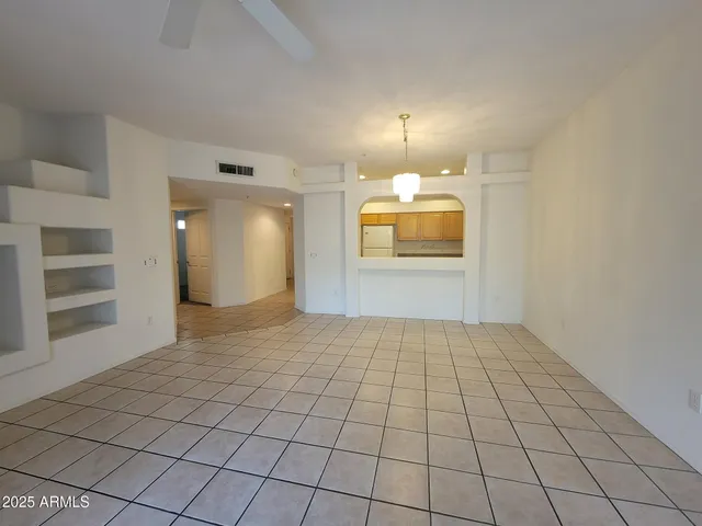 a kitchen with granite countertop a sink a stove and refrigerator