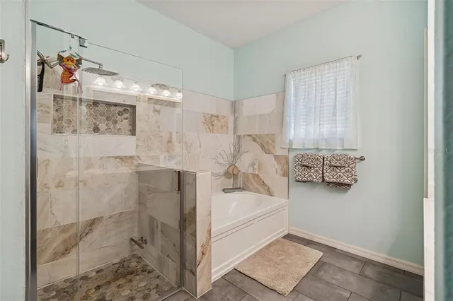 a bathroom with a tub and shower