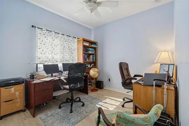 a view of a workspace with furniture and a window