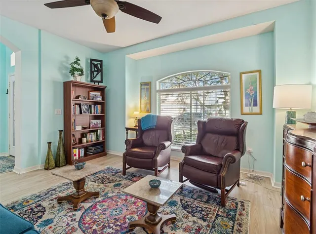 a living room with furniture a rug and a large window